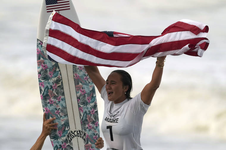 ASSOCIATED PRESS
                                Hawaii’s Carissa Moore celebrates winning the gold medal of the women’s surfing competition at the 2020 Summer Olympics, Tuesday, at Tsurigasaki beach in Ichinomiya, Japan.