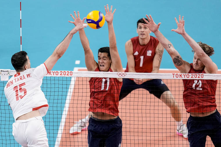 ASSOCIATED PRESS
                                Kamehameha alumnus Micah Christenson, second left, and United States’ Maxwell Holt, right, block the ball during a men’s volleyball preliminary round pool B match between United States and Tunisia at the 2020 Summer Olympics, Wednesday, in Tokyo, Japan.