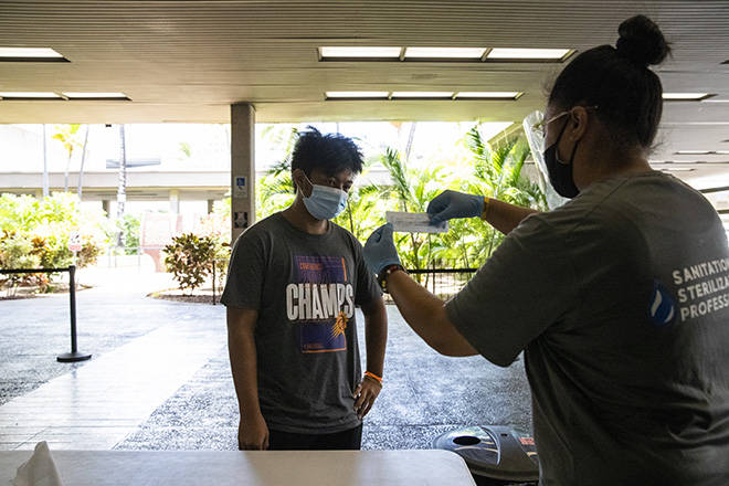 CINDY ELLEN RUSSELL / JULY 23
                                Health care worker Jacklynn Tema explains how to self administer a COVID-19 test at Terminal 2 of Daniel K. Inouye International Airport on July 23. The state’s 7-day average positivity rate for coronavirus testing is more than 5%.