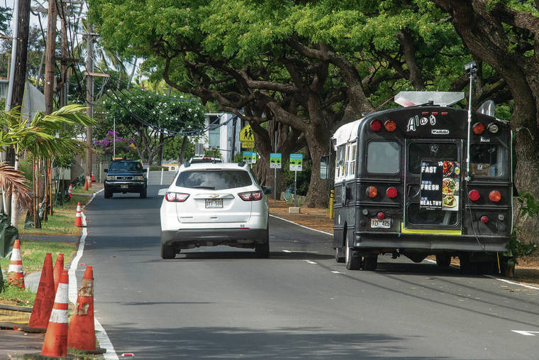 CRAIG T. KOJIMA / CKOJIMA@STARADVERTISER.COM
                                Residents complain new paid parking spaces take up what once was a traffic lane, making the thoroughfare effectively one-way with a sign ordering vehicles to yield to oncoming traffic, above.