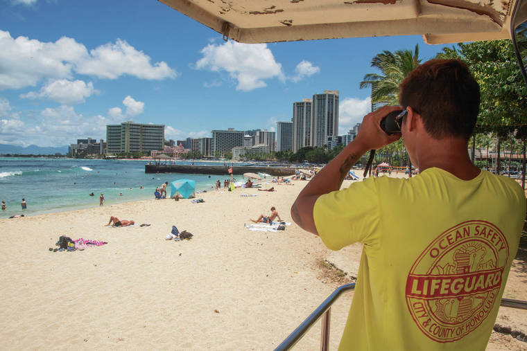 CRAIG T. KOJIMA / CKOJIMA@STARADVERTISER.COM
                                Honolulu Ocean Safety lifeguard John Quizon on duty in Waikiki.