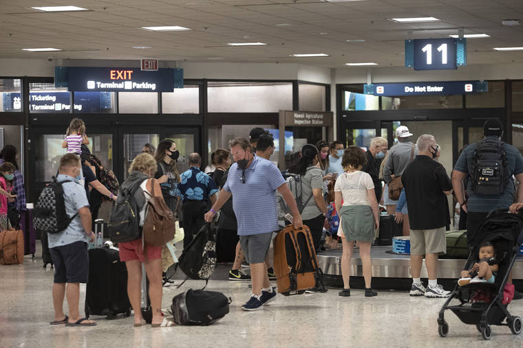 CINDY ELLEN RUSSELL / CRUSSELL@STARADVERTISER.COM
                                Travelers await their luggage at a baggage claim in Terminal 1 at Daniel K. Inouye International Airport on Thursday.