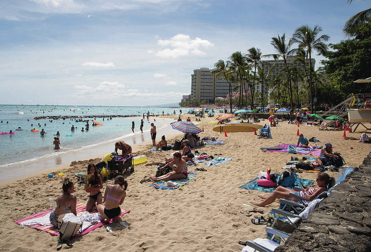 CINDY ELLEN RUSSELL / CRUSSELL@STARADVERTISER.COM
                                Hawaii saw 622 new coronavirus infections Friday, the highest since the start of the pandemic. Above, beachgoers gathered Thursday on the shores of Waikiki.