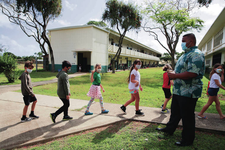 JAMM AQUINO / JAQUINO@STARADVERTISER.COM
                                Aikahi Elementary School Principal Keoki Fraser greets sixth graders as they return from first recess at Aikahi Elementary School in Kailua on March 22.