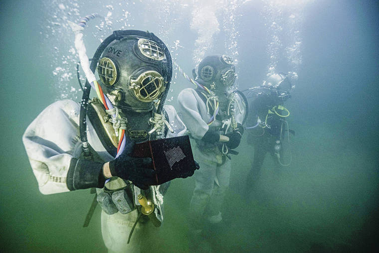 NATIONAL PARK SERVICE 
                                At top, Army divers wore World War II gear on Dec. 7, 2019, to inter the ashes of USS Arizona crew member Lauren Bruner on his ship, submerged in Pearl Harbor.
