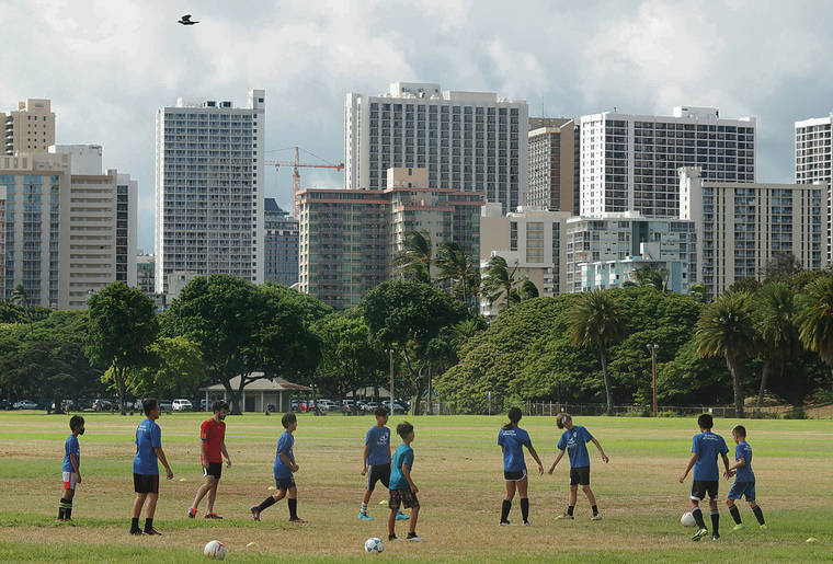 JAMM AQUINO / JAQUINO@STARADVERTISER.COM
                                The state Health Department is seeing a growing number of unvaccinated adults infect children under age 12, who are not eligible for COVID-19 vaccines, officials say. Above, youths played soccer Monday at Kapiolani Park.