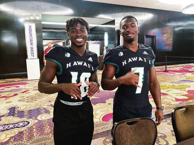 STEPHEN TSAI / STSAI@STARADVERTISER.COM
                                Hawaii defensive back Cortez Davis, left, and all-purpose offensive weapon Calvin Turner posed in their new jerseys during the Mountain West Conference meetings in Las Vegas.