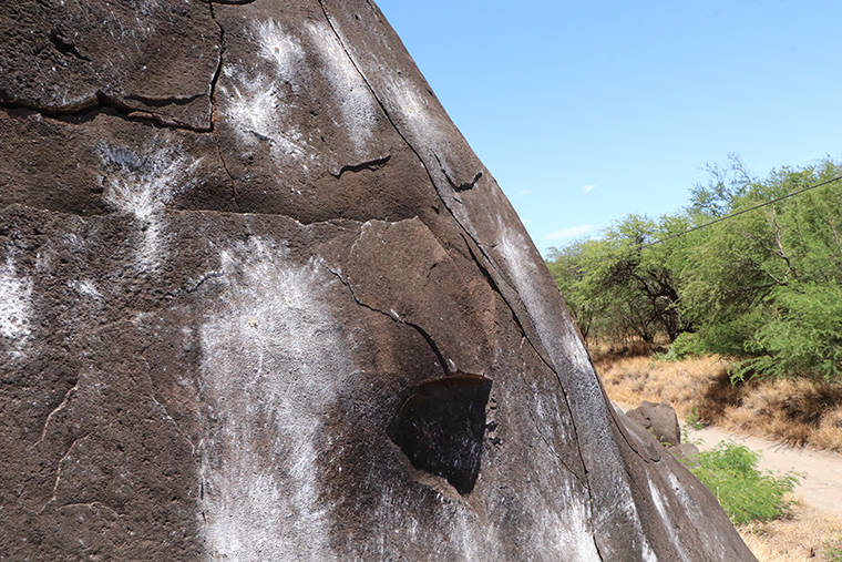 COURTESY DEPARTMENT OF LAND AND NATURAL RESOURCES
                                A collection of petroglyphs on the face of a cliff in Olowalu Valley on Maui were defaced with a paintball gun.