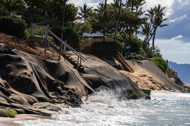 CINDY ELLEN RUSSELL / 2020
                                While the risk of maintaining property along the state’s shorelines has been evident for decades, state lawmakers passed a measure this year to make sure that prospective buyers are fully aware of those hazards. Water crashes onto fortifications called burritos near homes precariously perched above Sunset Beach on Oahu’s North Shore.