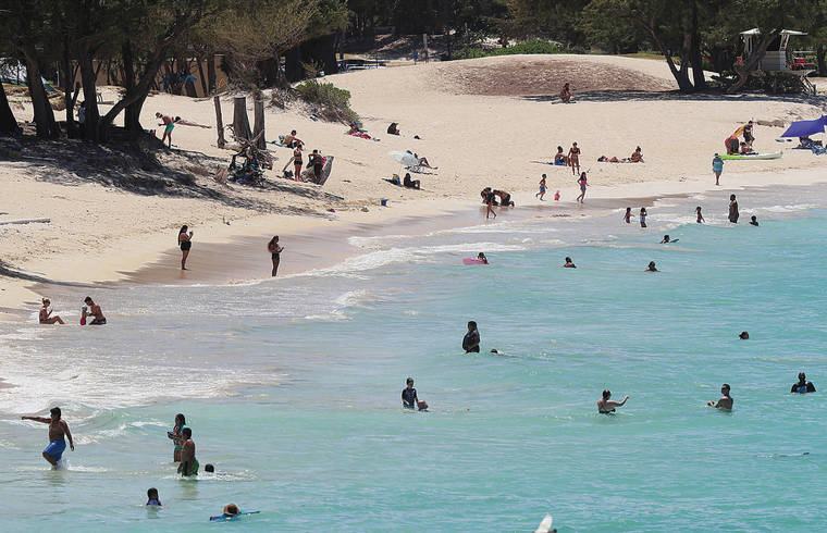 JAMM AQUINO / JUNE 30
                                People enjoy the beach in Kailua in June.