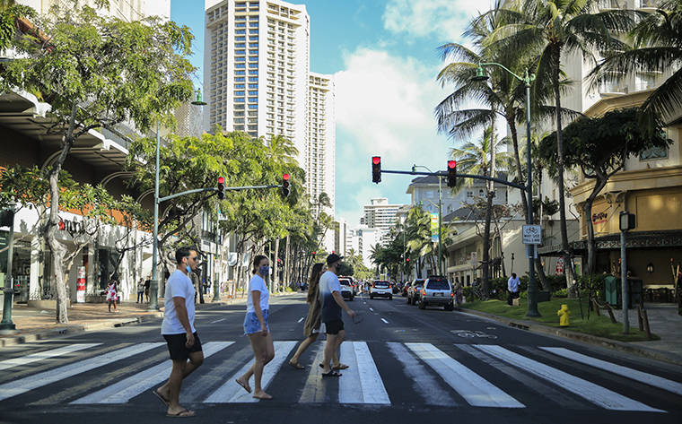 JAMM AQUINO / JAQUINO@STARADVERTISER.COM
                                Pedestrians crossed Kalakaua Avenue, March 7, in Waikiki.