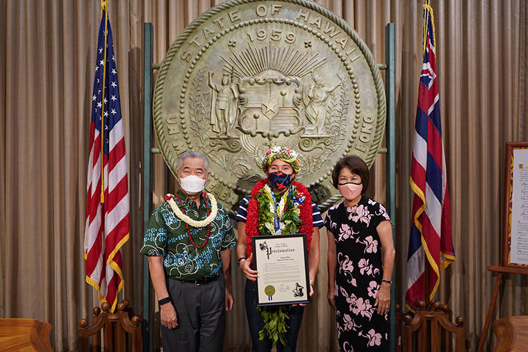 COURTESY GOV. DAVID IGE
                                Hawaii surfer Carissa Moore, middle, poses with Gov. David Ige and first lady Dawn Ige.