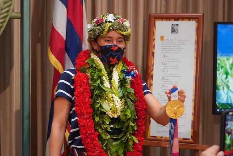 COURTESY GOV. DAVID IGE
                                Hawaii surfer Carissa Moore shows off the Olympic gold medal she won in surfing.