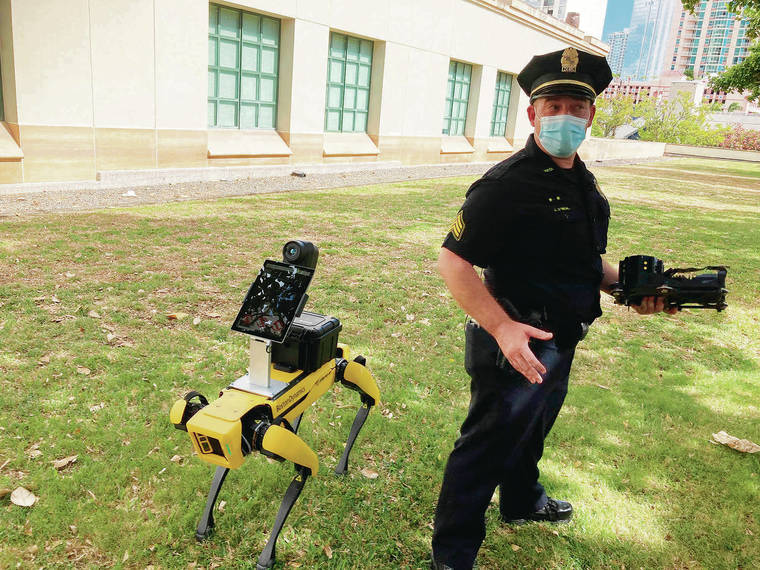 ASSOCIATED PRESS / MAY 14
                                Honolulu Police acting Lt. Joseph O’Neal demonstrates a robotic dog in Honolulu. Police officials experimenting with the four-legged machines say they’re just another tool, like drones or simpler wheeled robots, to keep emergency responders out of harm’s way.