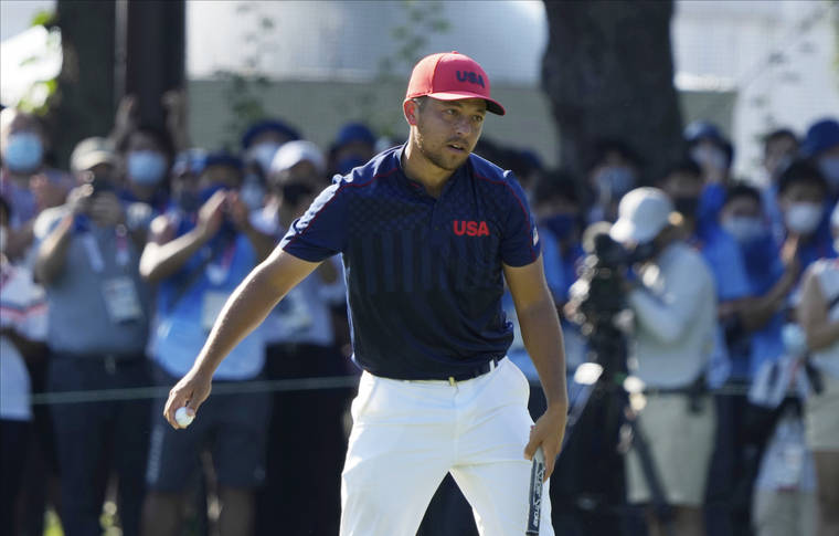 ASSOCIATED PRESS
                                Xander Schauffele of the United States celebrates winning gold in the men’s golf event.