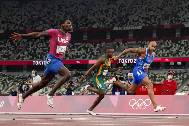 ASSOCIATED PRESS
                                Lamont Jacobs, right, of Italy, wins the men’s the 100-meter final at the 2020 Summer Olympics today in Tokyo.