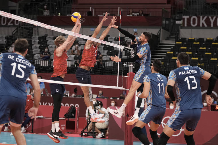 ASSOCIATED PRESS
                                Argentina’s Facundo Conte spikes a ball past Maxwell Holt, #12, and Taylor Sander, of the United States, during a men’s volleyball preliminary round pool B match, at the 2020 Summer Olympics, early Monday in Tokyo. The U.S. team lost and was eliminated from the competition.