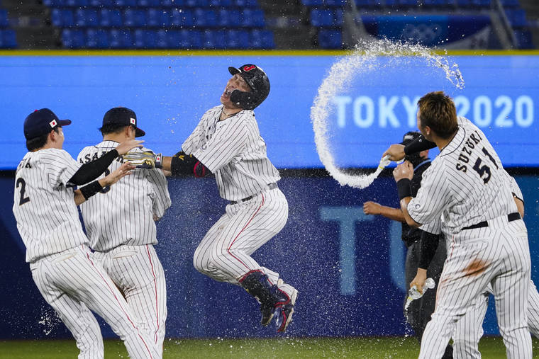 ASSOCIATED PRESS
                                Japan’s Takuya Kai, center, and teammates celebrated their win after a baseball game against the United States at the 2020 Summer Olympics, Monday, in Yokohama, Japan. Japan won 7-6.