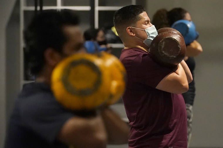 ASSOCIATED PRESS / 2020
                                Juan Avellan, center, and others wear masks while working out in an indoor class at a Hit Fit SF gym amid the coronavirus outbreak in San Francisco.