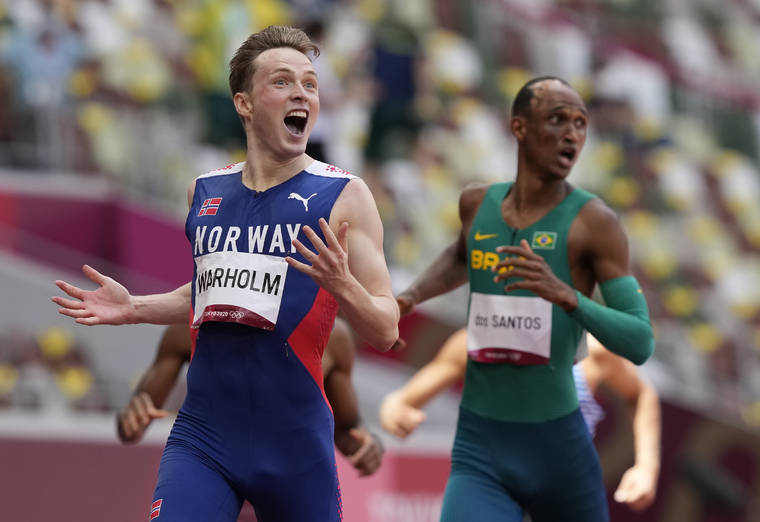 ASSOCIATED PRESS
                                Karsten Warholm, of Norway celebrates as he wins the gold medal in the final of the men’s 400-meter hurdles at the 2020 Summer Olympics, Tuesday, Aug. 3, 2021, in Tokyo, Japan. At right is Alison Dos Santos, of Brazil, who took the bronze.