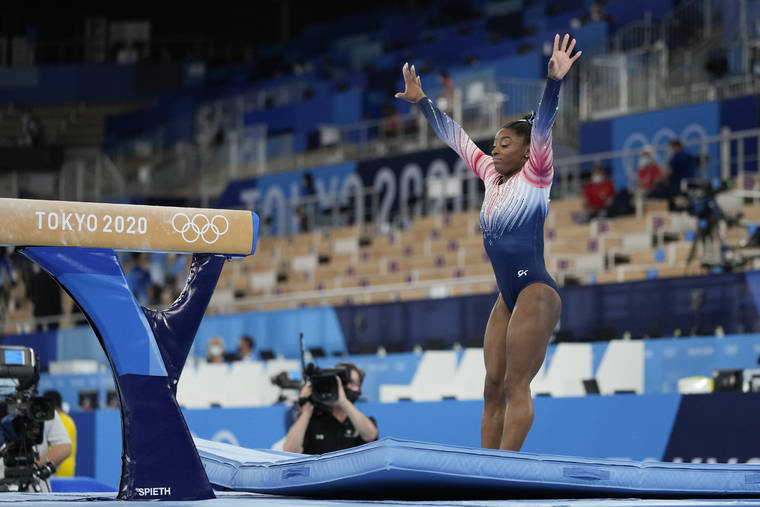 ASSOCIATED PRESS
                                Simone Biles, of the United States, warms up prior to the artistic gymnastics balance beam final at the 2020 Summer Olympics in Tokyo, Japan.