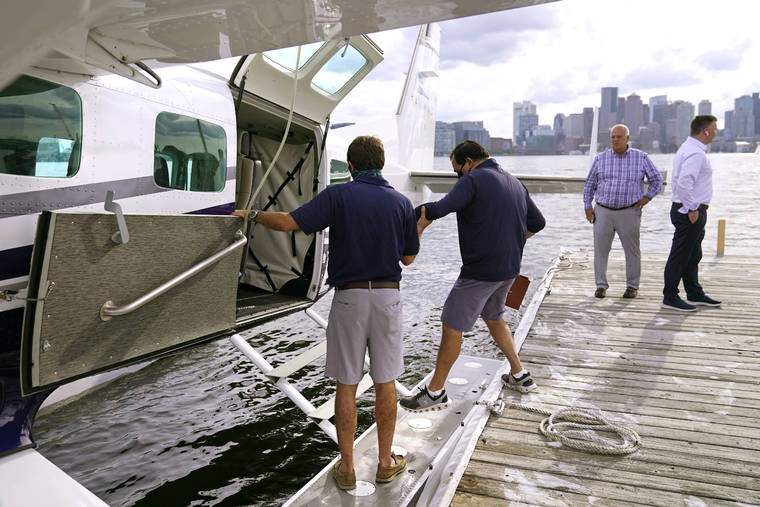 ASSOCIATED PRESS
                                A passenger loads onto a Tailwind Air commuter seaplane in Boston Harbor in Boston. The airline began daily flight service Tuesday to and from New York Harbor.