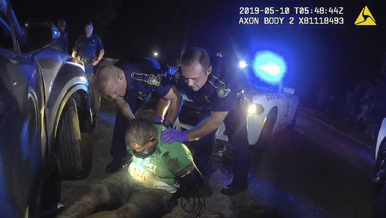 LOUISIANA STATE POLICE VIA ASSOCIATED PRESS
                                Louisiana state troopers held Ronald Greene, in May 2019, before paramedics arrived outside of Monroe, La. The video shows Louisiana state troopers stunning, punching and dragging Greene as he apologizes for leading them on a high-speed chase.