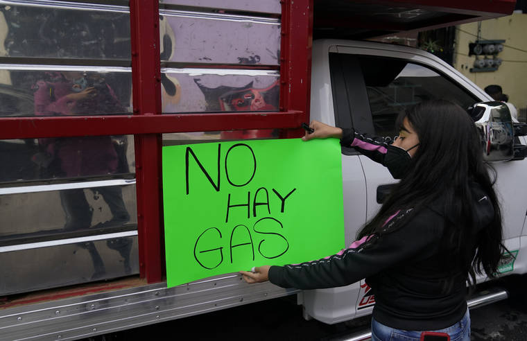 ASSOCIATED PRESS
                                A woman places a sign that reads in Spanish ¨No gas¨ on a LP gas delivery truck in Mexico City. Crews that distribute LP gas in Mexico’s capital went on strike Tuesday after the government imposed price controls on the fuel that most Mexicans use to cook and heat water.