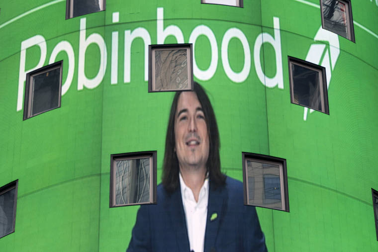 ASSOCIATED PRESS
                                Vladimir Tenev, CEO and co-founder of Robinhood, is shown on an electronic screen at Nasdaq in New York’s Times Square following his company’s IPO, Thursday.