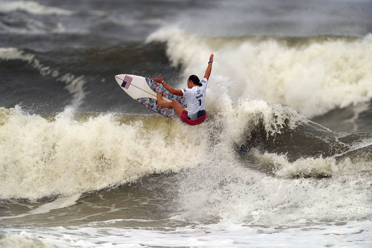 ASSOCIATED PRESS
                                Carissa Moore, of the United States, competed, July 27, during the gold medal heat in the women’s surfing competition at the 2020 Summer Olympics at Tsurigasaki beach in Ichinomiya, Japan. The first Olympic gold medalist for surfing, Moore, is the only Native Hawaiian surfer at the Games.