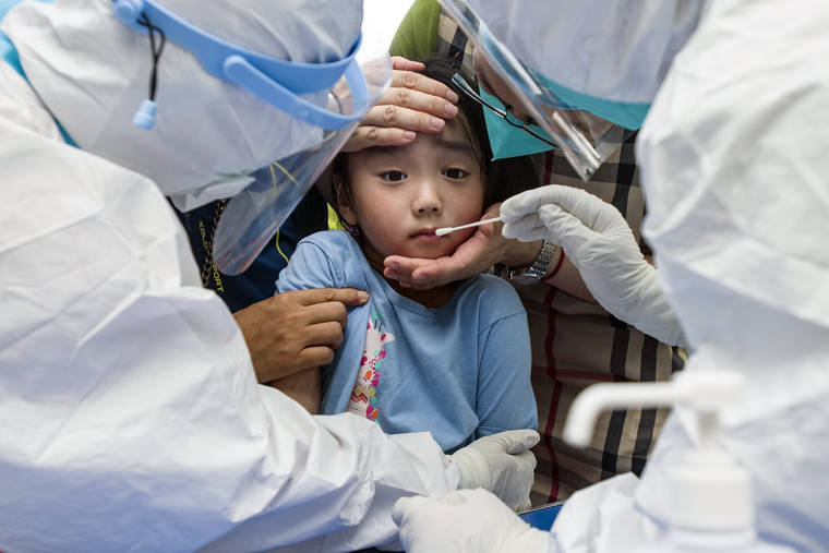CHINATOPIX VIA ASSOCIATED PRESS
                                A child reacted to a throat swab during mass testing for COVID-19 in Wuhan in central China’s Hubei province, Tuesday. The coronavirus’s delta variant is challenging China’s costly strategy of isolating cities, prompting warnings that Chinese leaders who were confident they could keep the virus out of the country need a less disruptive approach.