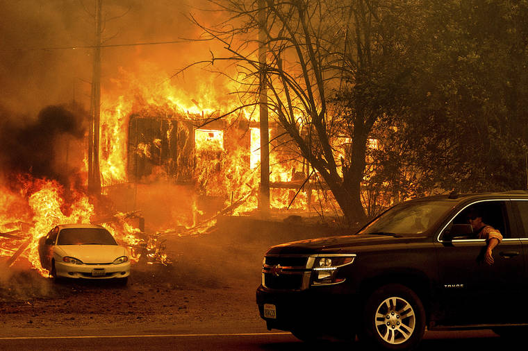 ASSOCIATED PRESS
                                Flames from the Dixie Fire consume a home on Highway 89 south of Greenville on Thursday in Plumas County, Calif.