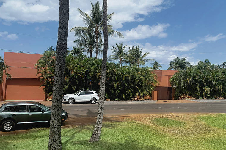 J.D. KIM VIA ASSOCIATED PRESS
                                Part of a Maui mansion is seen Thursday from a street in Kihei. The $45 million cash sale of the eight-bedroom house reflects a hot real estate market where the median price of a Maui home topped $1.1 million in June.