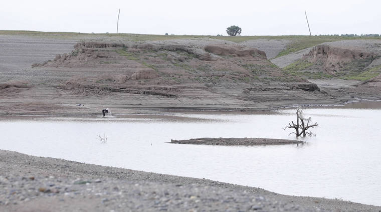 ASSOCIATED PRESS
                                In this photo taken from a video shot on Wednesday in Wad el-Hilu, Sudan, a man washes in the Setit river, known in Ethiopia as Tekeze River.