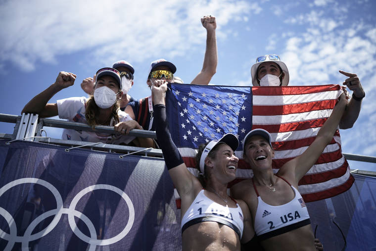 ASSOCIATED PRESS
                                April Ross, left, of the United States, and teammate Alix Klineman celebrate winning a women’s beach volleyball Gold Medal match against Australia at the 2020 Summer Olympics, Friday, in Tokyo, Japan.