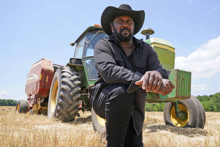 ASSOCIATED PRESS
                                Farmer John Boyd Jr., poses for a portrait during a break from bailing hay at his farm in Boydton, Va.