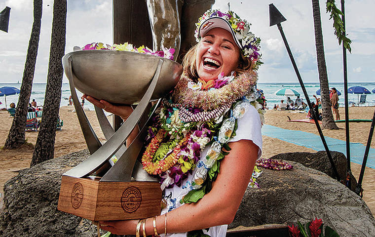 DENNIS ODA / 2019
                                Carissa Moore posed in front of the Duke Kahanamoku statue in Waikiki after she clinched her fourth World Surfing League championship title at Honolua Bay, Maui. She also learned the she was the first woman selected for the U.S. Olympic surf team.
