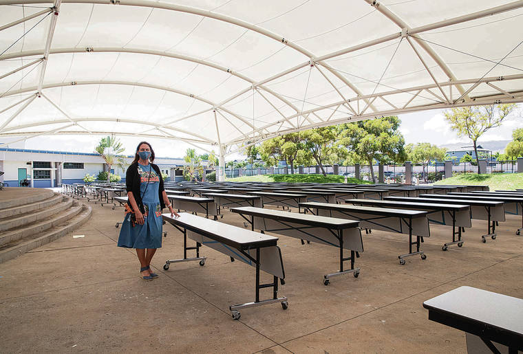 CINDY ELLEN RUSSELL / CRUSSELL@STARADVERTISER.COM
                                Ewa Makai Middle School Principal Kim Sanders stood Tuesday under a covered outdoor amphitheater that now serves as the cafeteria. There are three lunch shifts to accommodate the school’s 1,270 students.