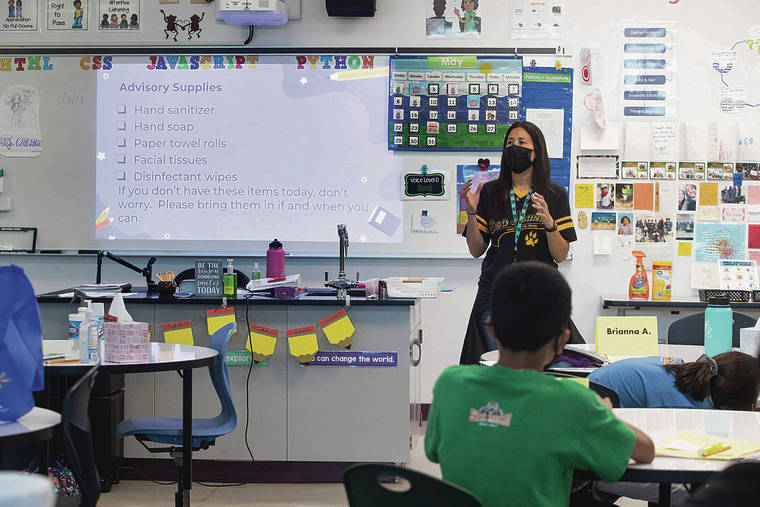 CINDY ELLEN RUSSELL / CRUSSELL@STARADVERTISER.COM
                                Ewa Makai Middle School sixth grade students returned back to school for an orientation and in class learning on Tuesday, August 3, 2021. Pictured is Coding instructor Miki Cacace with a list of supplies for her advisory students to bring to class.