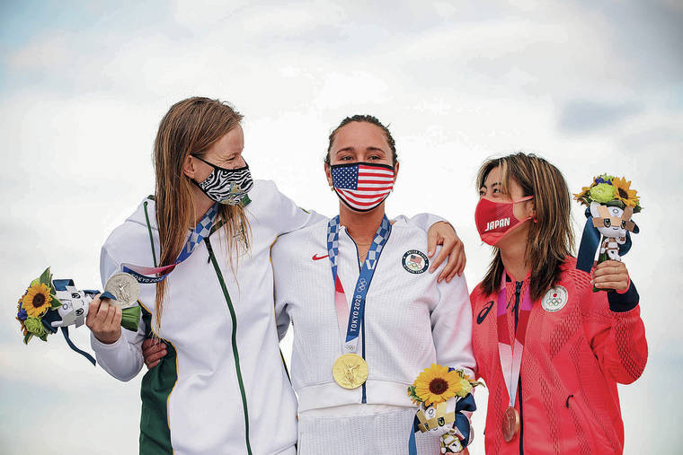 OLIVIER MORIN / VARIOUS SOURCES / AFP
                                USA’s Carissa Moore, center, posed with her medal along with silver medalist Bianca Buitendag, left, of South Africa, and bronze medalist Amuro Tsuzuki of Japan at the Tsurigasaki Beach, in Chiba on July 27.