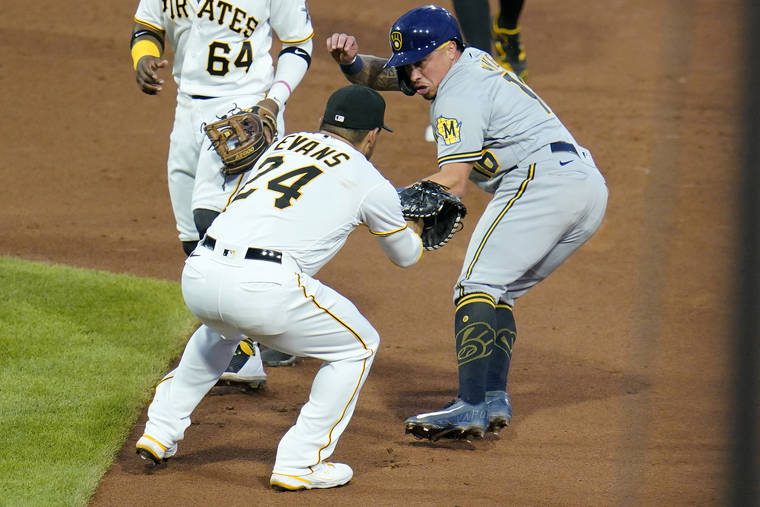 ASSOCIATED PRESS
                                Milwaukee’s Kolten Wong, right, is caught in a rundown between first and second by Pittsburgh Pirates first baseman Phillip Evans (24) and Rodolfo Castro (64) during the fifth inning of a baseball game in Pittsburgh on Thursday.