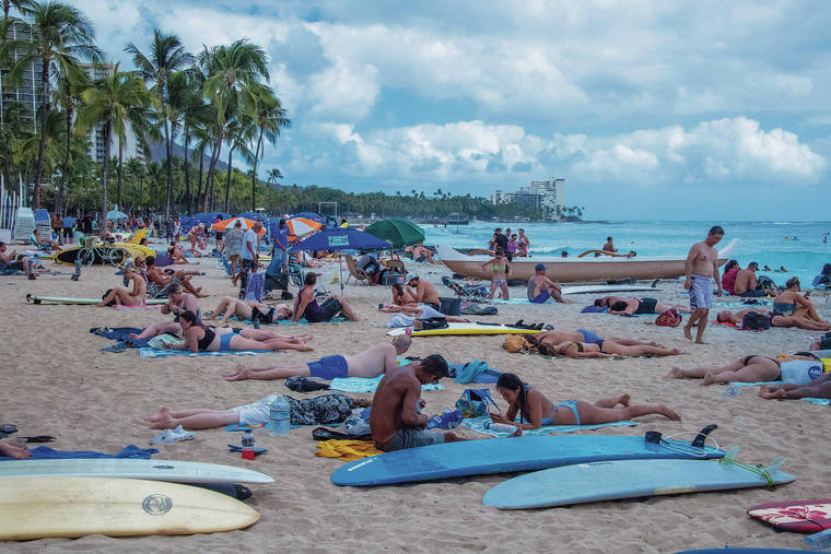 CRAIG T. KOJIMA / CKOJIMA@STARADVERTISER.COM
                                Waikiki Beach was filled with sunbathers Saturday.