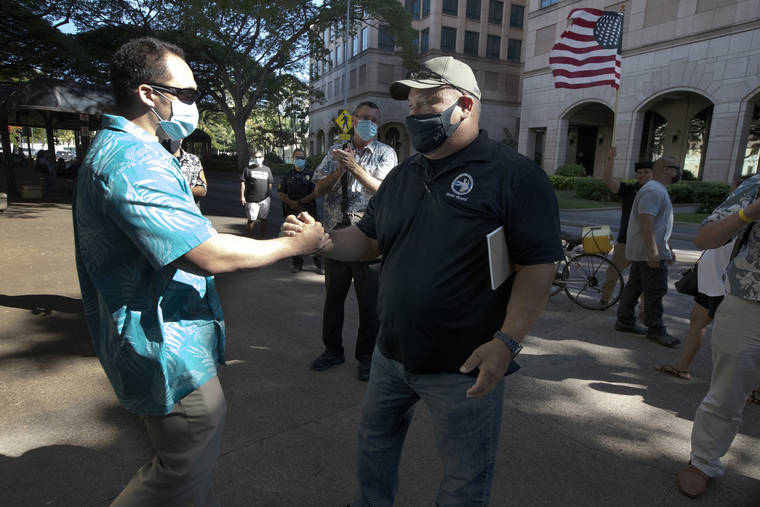 GEORGE F. LEE / GLEE@STARADVERTISER.COM
                                Above, officer Zackary Ah Nee shook hands with police union President Malcolm Lutu.
