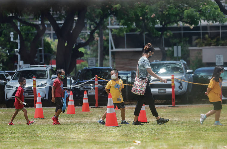JAMM AQUINO / AUG. 13
                                As an alternative in view of the delta variant surge, the state Department of Education is exploring an option of hiring out-of-state teachers for distance learning of isle students. Students wearing masks walk back to class in socially distant order after outdoor activity at Queen Kaahumanu Elementary School.