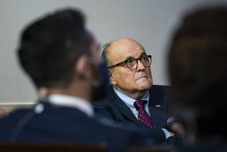 NEW YORK TIMES / 2020
                                Rudy Giuliani, then-President Donald Trump’s former personal lawyer, listens as Trump speaks during a news briefing in the White House in Washington.