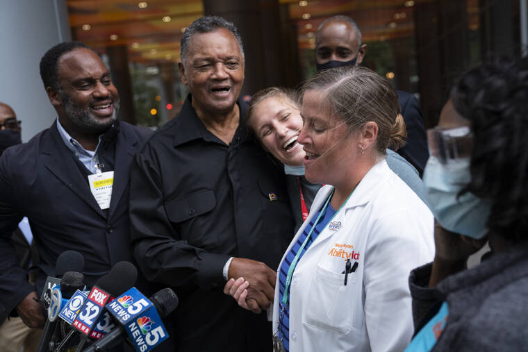 E. JASON WAMBSGANS/CHICAGO TRIBUNE VIA AP
                                The Rev. Jesse Jackson jokes with his doctor, Dr. Leslie Rydberg, right, and physical therapist Talia Shapiro, center, as he is released from therapy at the Shirley Ryan AbilityLab after recovering from COVID-19.