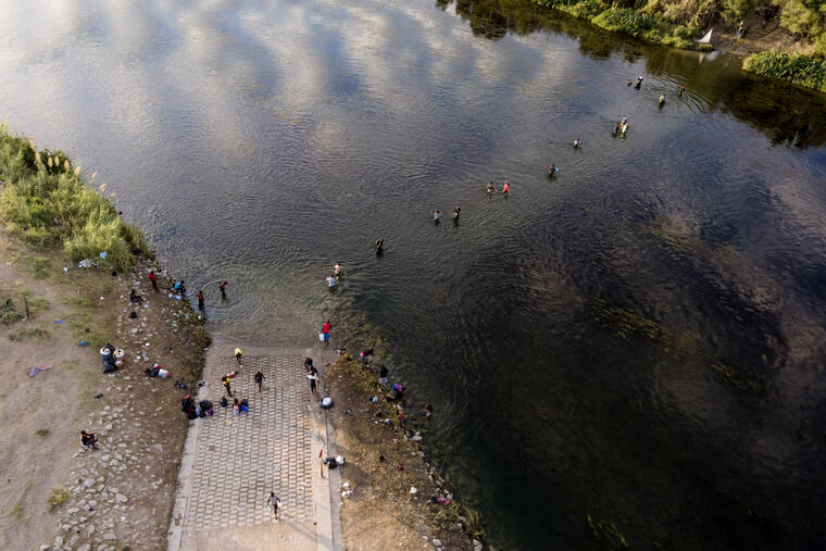 ASSOCIATED PRESS
                                Migrants, many from Haiti, wade back and forth between Texas and Mexico across the Rio Grande in Del Rio, Texas.