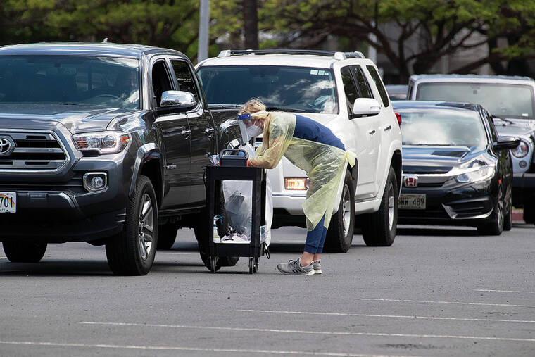 GEORGE F. LEE / GLEE@STARADVERTISER.COM
                                The number of COVID-19 tests coming back positive has declined statewide, to 6.9% Monday from 7.8% two weeks ago. At left, cars lined up Monday at the coronavirus testing site at the Blaisdell Center.