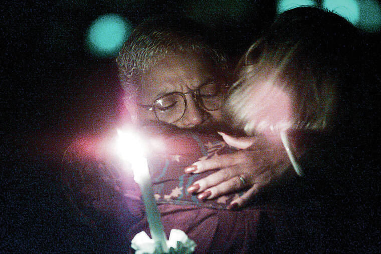 GEORGE F. LEE / 2001
                                Marsha Joyner, left, hugs Fran Orian on the grounds of Iolani Palace during a candlelight vigil held in remembrance of the victims of the terrorist actions at the World Trade Center in New York, the Pentagon in Arlington, Va., and a plane crash near Shanksville, Pa.