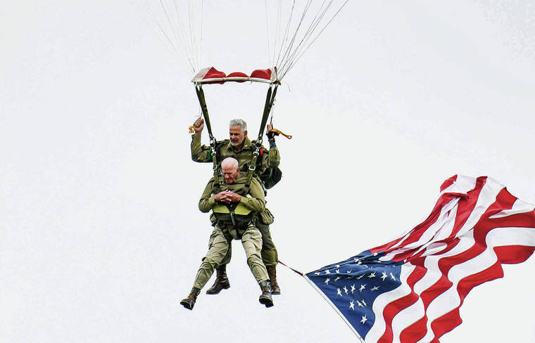 TRIBUNE NEWS SERVICE
                                U.S. World War II veteran Tom Rice (front) takes part in a parachute drop over Carentan, Normandy, north-western France, on June 5, 2019, as part of D-Day commemorations marking the 75th anniversary of the World War II Allied landings in Normandy.